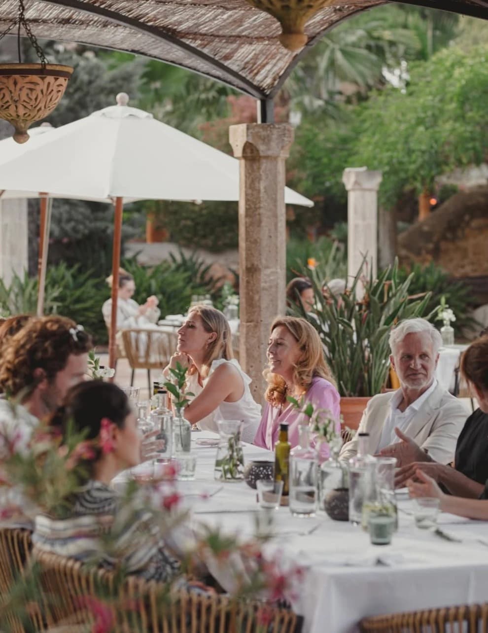 Henning Bensland at an outdoor group dinner under a canopy at Cal Reiet, guests seated around a long table
