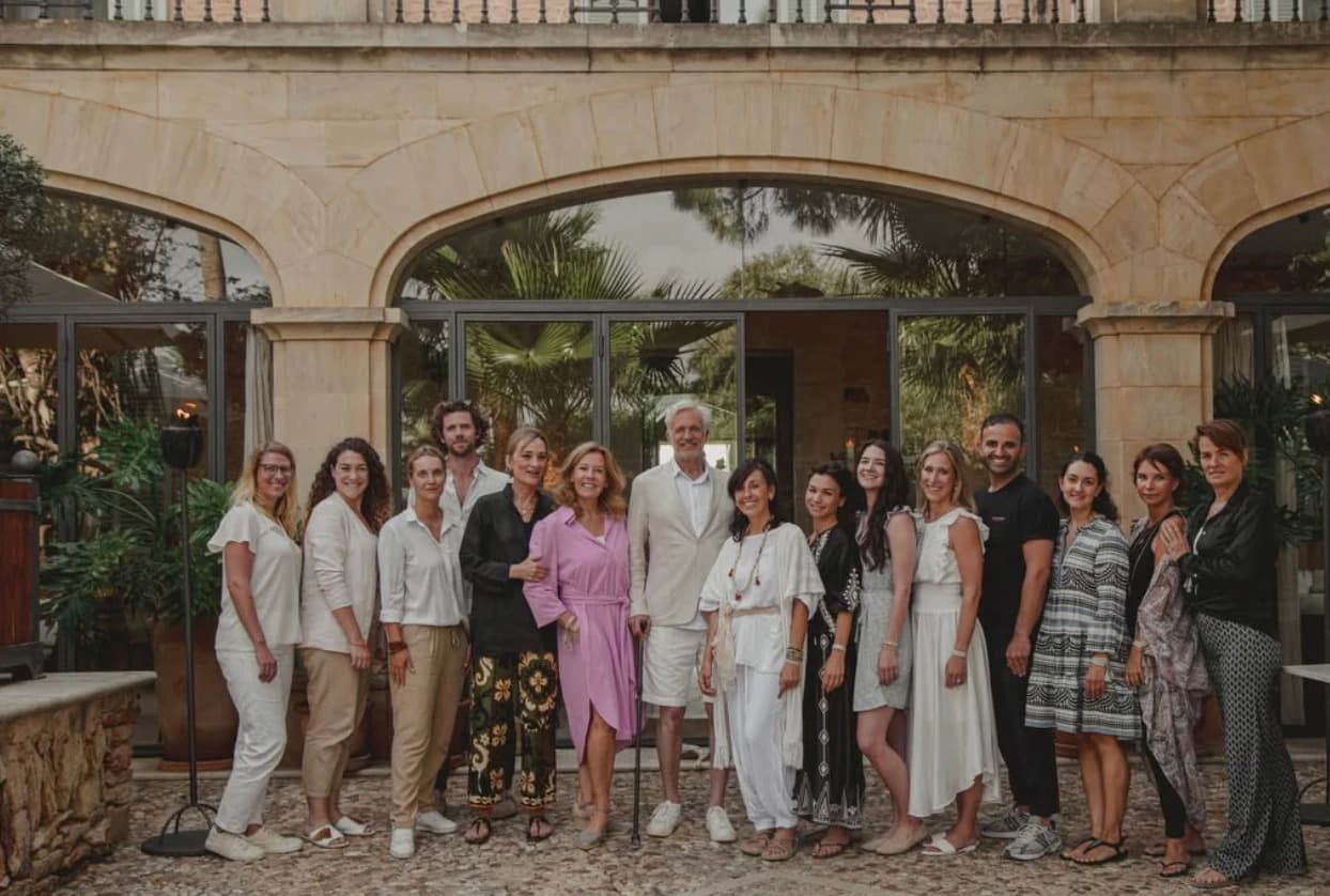 Henning and Petra Bensland with the Cal Reiet team gathered in front of the retreat's main building