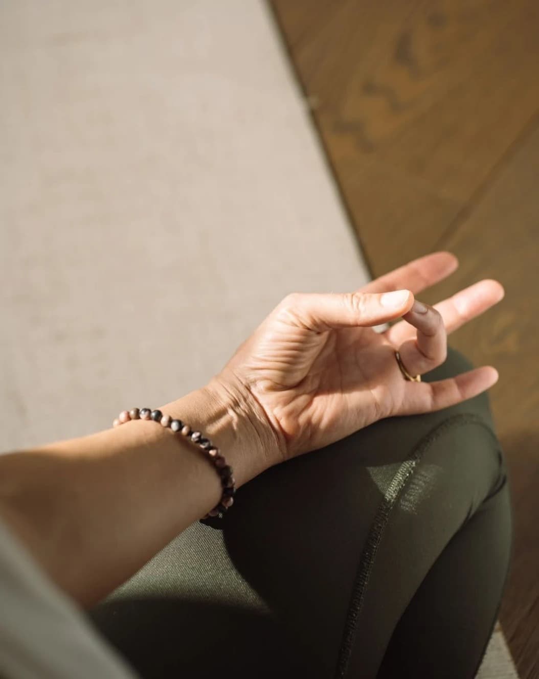 Close-up of a hand in a mudra gesture during a mindfulness session